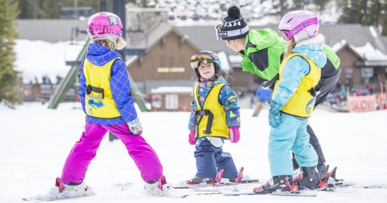 Children enjoys skiing with their mentor in Whitefish, Montana