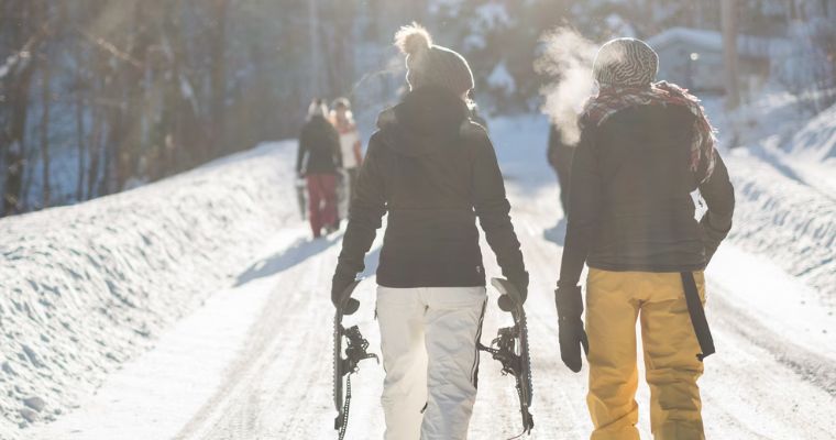 Tourists going to the mountain top for Snowshoeing in Whitefish, Montana