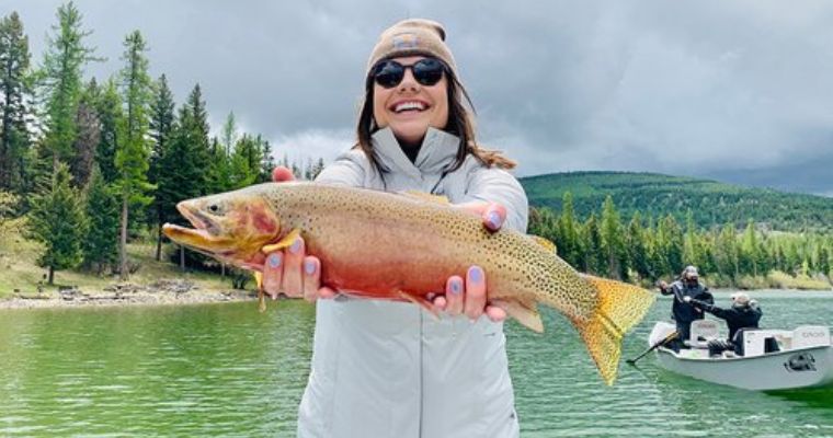 Tourist happy with her successful fishing adventure in Whitefish, Montana