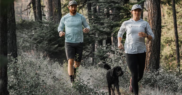 The couple wears Forloh product while jogging in the forest with their cute dog
