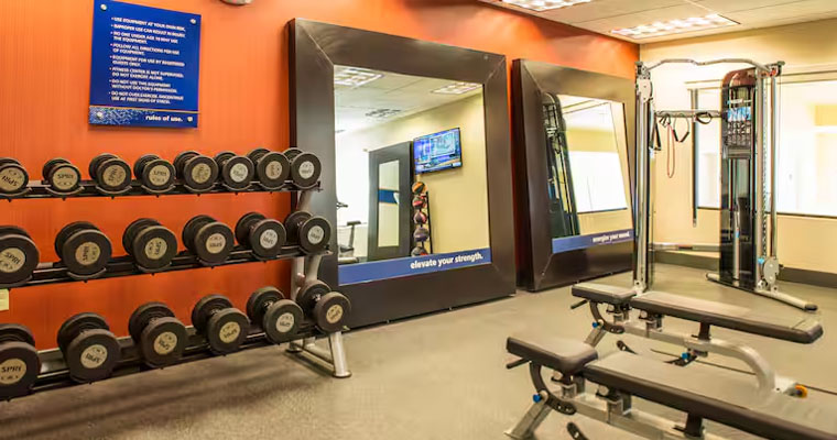 Inside the gym of Hampton Inn & Suites Whitefish  with different gym equipment's 