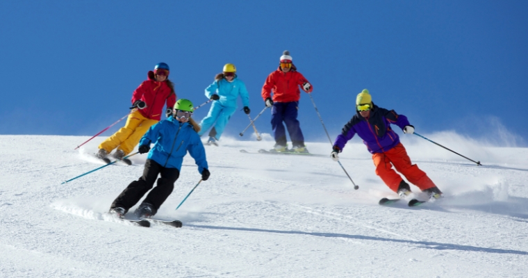 A group of skiers navigate a snowy slope at Whitefish Mountain Resort during the ski season.