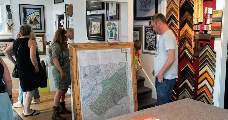 Tourists enjoy viewing art gallery in Whitefish during Whitefish Gallery Walk event