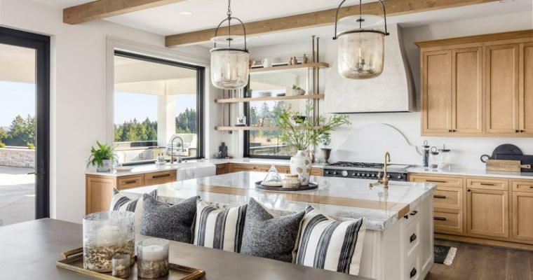 A spacious kitchen featuring a large island and elegant wooden cabinets