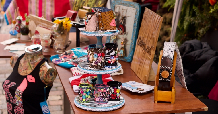 A table displaying various crafts and artisanal creations at the Whitefish Arts Festival.