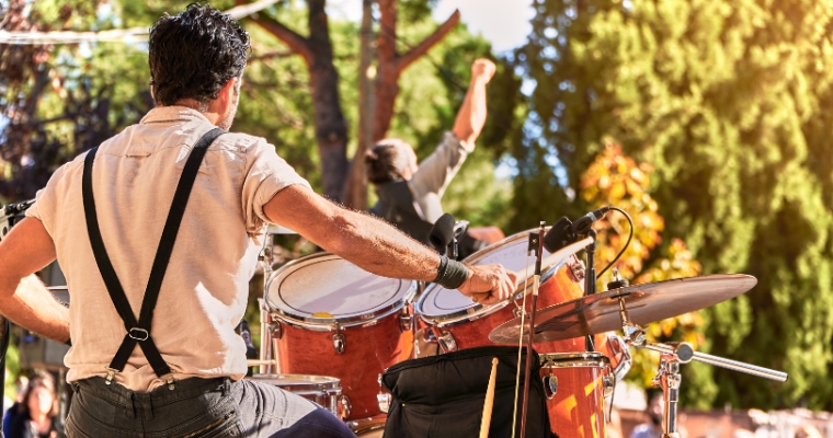 A group of band performing in a park at the Whitefish Arts Festival, showcasing live music and performance arts.