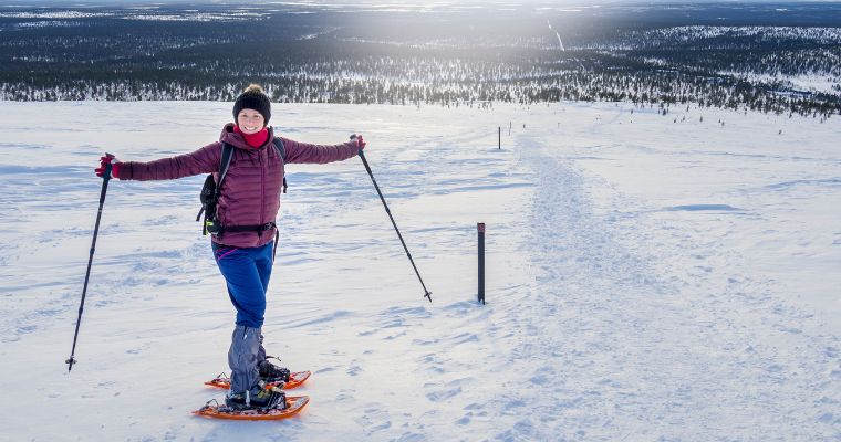 A woman stands confidently on her skis, surrounded by a beautiful snowy slope in Whitefish, ready for an adventure.