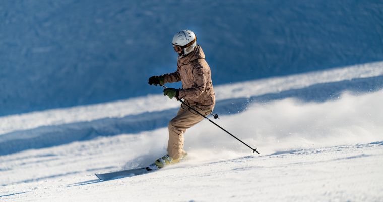 A skier descends a snow-covered slope in Whitefish, Montana, showcasing the thrill of winter sports and adventure.