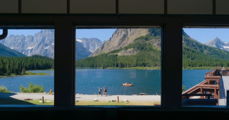 A stunning view of Montana's mountains framed by a cozy window, showcasing nature's beauty and tranquility.