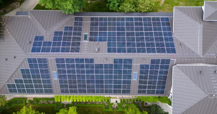 Aerial view of a roof featuring solar panels, showcasing sustainable and eco-friendly home building in Whitefish.