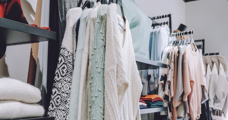A clothing store in Whitefish, Montana, featuring racks of various clothes at Chill Clothing Company.