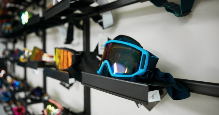 A collection of goggles arranged on a wall and shelf at Snow Ghost Outfitters, located in Whitefish, Montana.