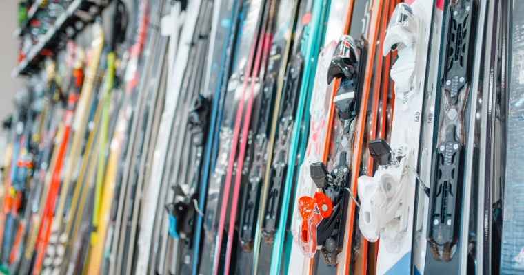 A row of skis for sale at Sportsman & Ski Haus in Whitefish, Montana, highlighting winter sports gear available for shoppers.