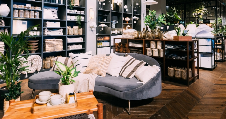 A vibrant store in Whitefish, Montana, filled with various plants and stylish furniture for home decor.