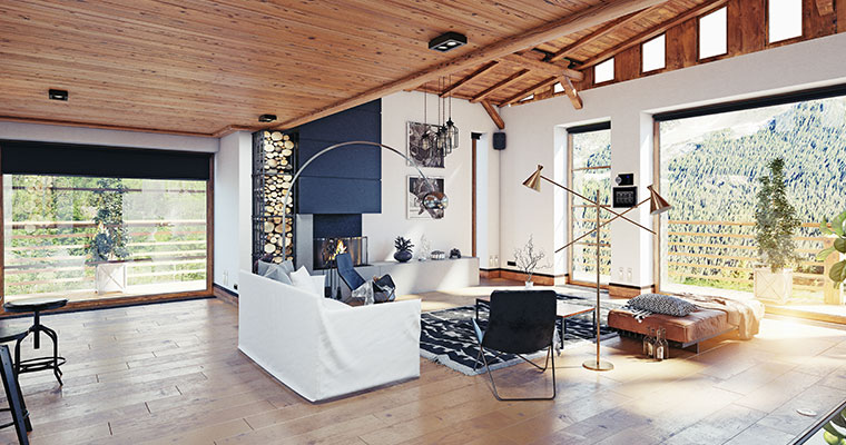 A cozy living room featuring a wooden ceiling and a large window, showcasing the final touches of a Montana home interior.