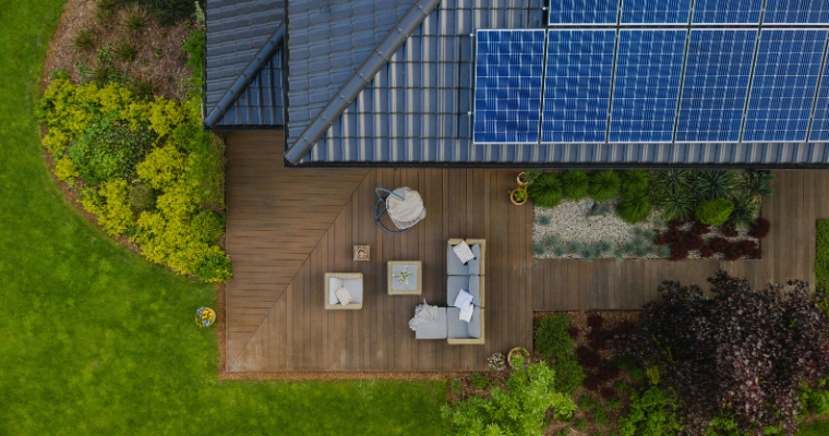 Aerial view of a house in Whitefish, Montana, featuring solar panels on the roof, part of the Net-Zero Homes initiative.