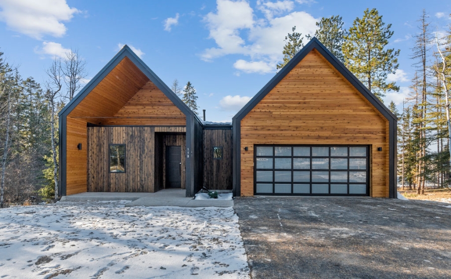 Stylish modern residence with garages and wood siding, crafted by Montana Home Builders.